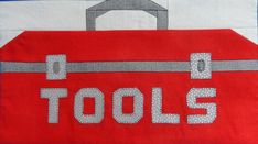 a red piece of cloth with the words tools on it and a bag in the middle