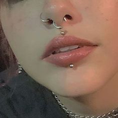 a woman with piercings on her nose