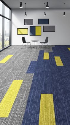 an empty room with yellow and blue carpeting