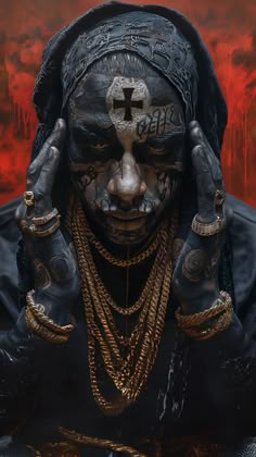 a man with his face painted in black and gold is holding his hands to his ears