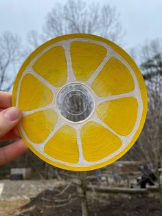 a person holding up a yellow frisbee in the air