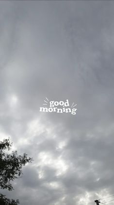 the words good morning written in white on a cloudy sky