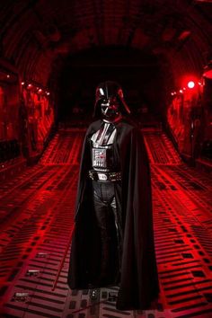 darth vader standing in the dark tunnel with red light coming from behind him