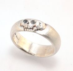 This is the widest of my Memento Mori skull rings at 7mm. Cast in sterling silver and given a brushed finish after oxidizing the recesses of the skull. Heavyweight, very comfortable.SterlingI made these Memento Mori rings for my older sister Jill, a famous poet and Professor who turned 50 this year. Well, I made the first one for her, the second because I wanted to make more knees, the third because I wanted to redo a jawbone. Skeletons are rad, even for nerds like me. And they look better the m Mori Jewelry, Memento Mori Skull, Memento Mori Jewelry, Memento Mori Ring, Hand Jewellery, Skull Rings, Older Sister, Skull Jewelry, Jewelry Style