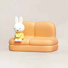 a toy rabbit sitting on top of a couch