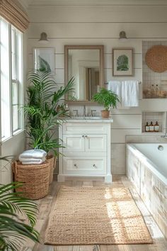 a bath room with a tub a sink and a mirror on the wall next to a potted plant