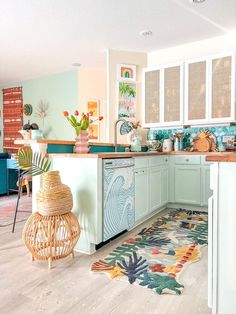 the kitchen is decorated with colorful rugs and tropical decor on the countertop, along with an island in the middle