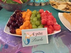 there are many different types of fruits on this plate and the sign says oyster pearls