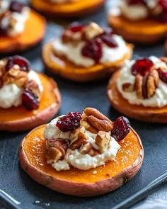 mini sweet potatoes topped with whipped cream, pecans and cranberry toppings