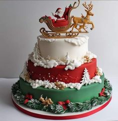 a christmas cake with santa riding in a sleigh and reindeers on top