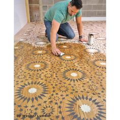 a man is working on a floor with tile