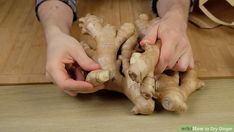 a person is holding some ginger on the floor