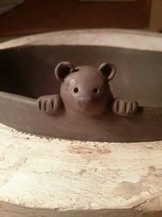 there is a clay bear sitting in the water