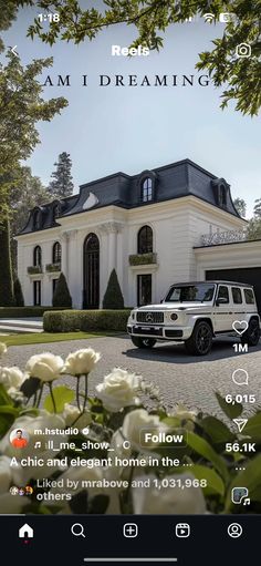 a white truck parked in front of a large house with flowers on the driveway and trees