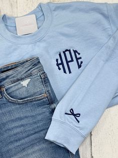 a pair of jeans and a sweatshirt with monogrammed letters