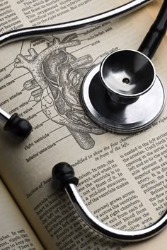 a stethoscope laying on top of an open book