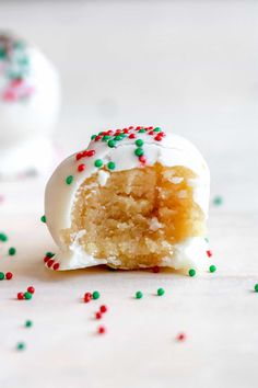 a half eaten cake ball with white frosting and sprinkles on it