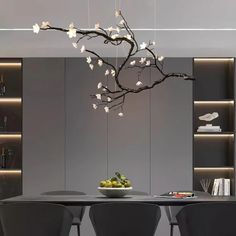 a dining room table with chairs and a bowl of fruit on it