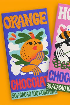 two orange chocolates are sitting next to each other on a yellow background with the same design