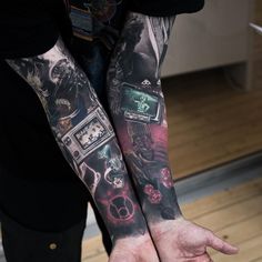 two people with tattoos on their arms holding each other's hands in front of them