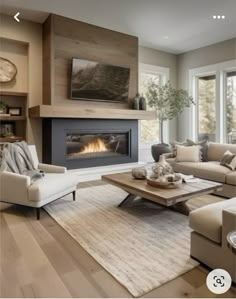 a living room filled with furniture and a flat screen tv mounted on the wall next to a fire place