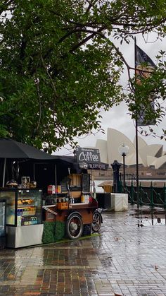 an old car parked in front of a food stand