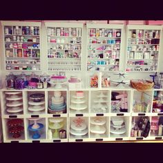 the shelves are filled with many different types of beauty products and containers for makeup on them