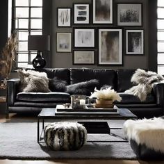 a living room with black leather furniture and pictures on the wall above it's coffee table