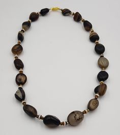 These Beads are Antique Ancient agate Stone Beads it's very old beads the Necklace has been made recently and the lock is Gold Plated its also new the Beads Are real Old more then 1000 years old Its called Sulimani Agate Banded Beads Stone Agate Origin Yeman Length 54 Brown Beaded Necklace With Oval Gemstone Beads, Brown Beaded Necklaces With Oval Natural Stones, Earthy Agate Beaded Necklaces With Round Beads, Artisan Agate Beaded Necklaces With Faceted Beads, Artisan Agate Beaded Necklaces With Large Beads, Artisan Agate Beaded Necklace With Large Beads, Artisan Beaded Necklace With Large Agate Beads, Artisan Agate Beaded Necklace With Faceted Beads, Oval Agate Beaded Necklaces