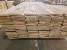 stacks of wooden planks stacked on top of each other in a warehouse or factory