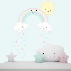 there are stars, clouds and rainbows on the shelf in front of the wall