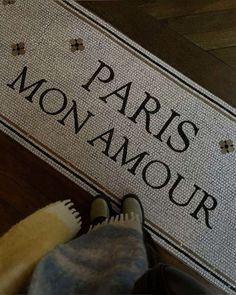 someone standing on the floor in front of a sign that says, paris is glamour