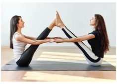 two women are doing yoga on their mats