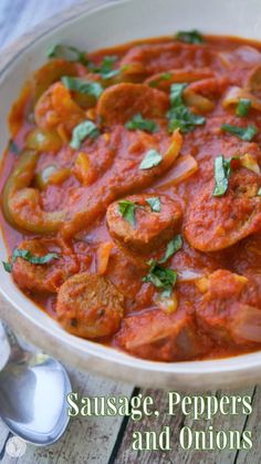 sausage, peppers and onions stew in a white bowl