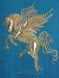 an intricately designed horse on blue fabric