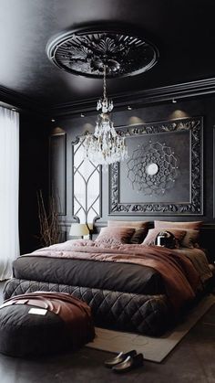 a large bed sitting in a bedroom next to a chandelier hanging from the ceiling