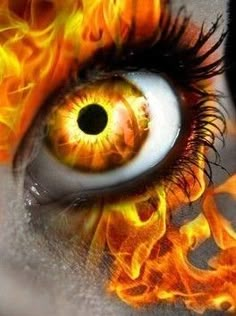 an eye with flames painted on it's iris and the center part of its iris