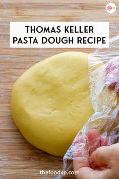 a person holding a dough in their hand with the words thomas keller pasta dough recipe