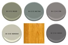 several different shades of gray paint with wood flooring