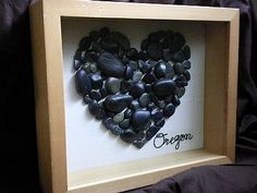 a heart made out of rocks with the word oregon written on it in a shadow box