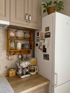 a white refrigerator freezer sitting inside of a kitchen next to a wooden counter top