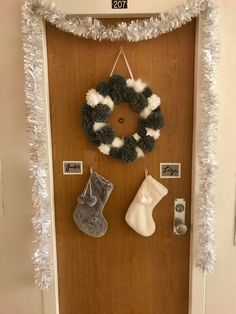 a door decorated for christmas with stockings and stocking