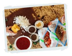 the meal is prepared and ready to be eaten on the counter top, including rice, beans, bread, and sauces