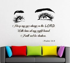 a living room with a couch and wall decal that says keep my eyes on the lord