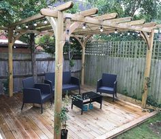 a wooden deck with two chairs and a table