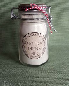 an egg nog drink mix in a glass jar with red and white twine