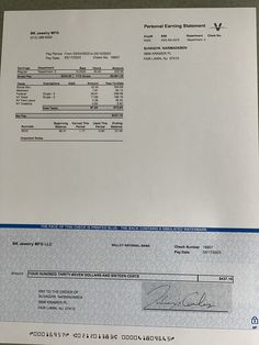 a close up of a cheque paper on a table with a pen and pencil