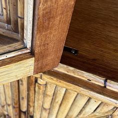 an open wooden cabinet door with wood slats on the bottom and side paneling