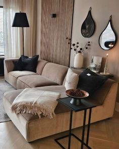 a living room filled with furniture and decor on top of a hard wood floored floor