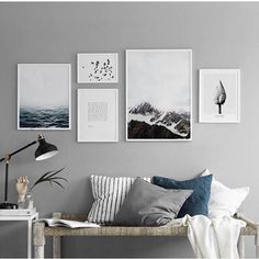 an image of a living room with pictures on the wall and photos hanging above it